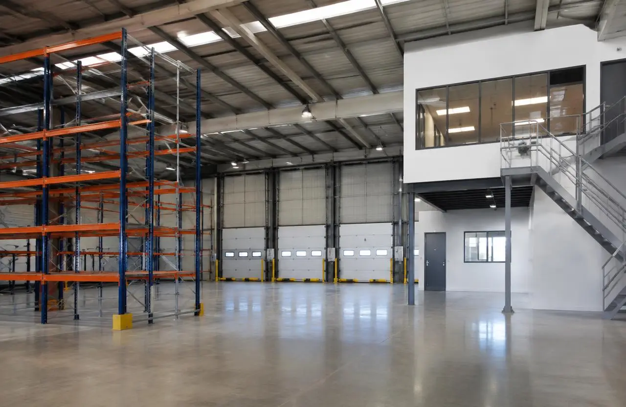 Illustrative warehouse with racking, loading doors and a mezzanine office